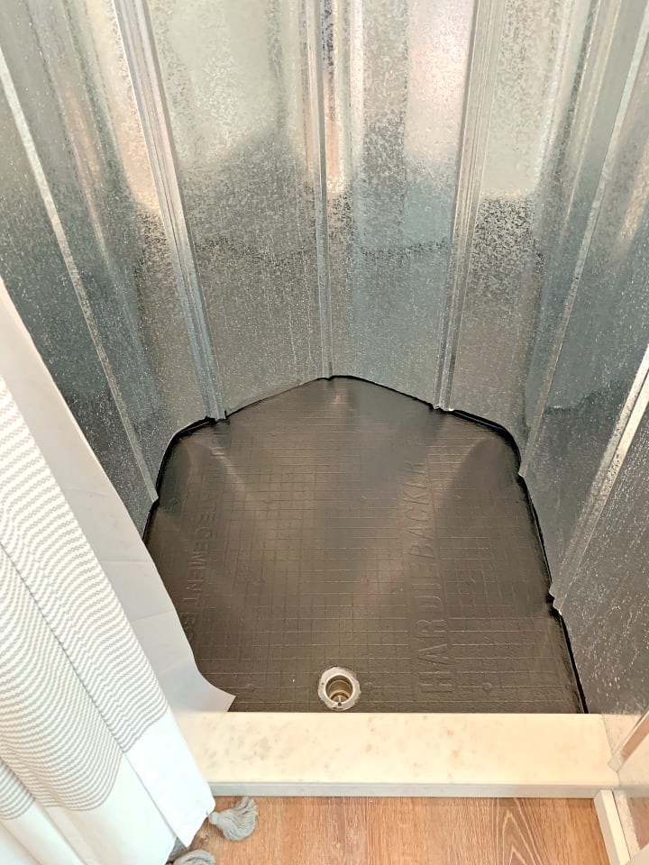 black painted shower floor with metal shower walls in an RV