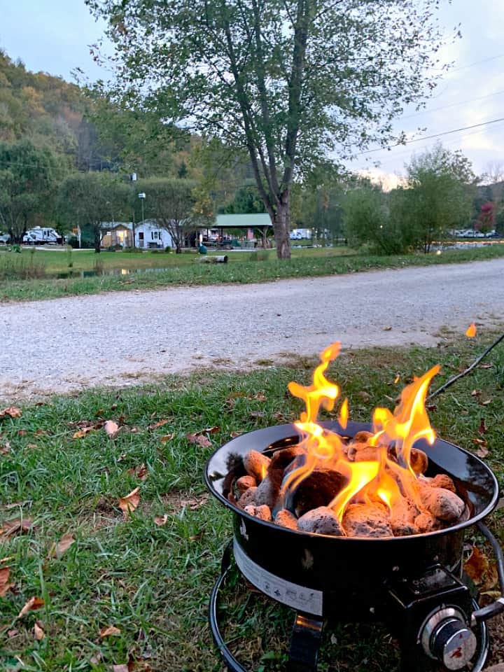 propane fire pit burning at campsite