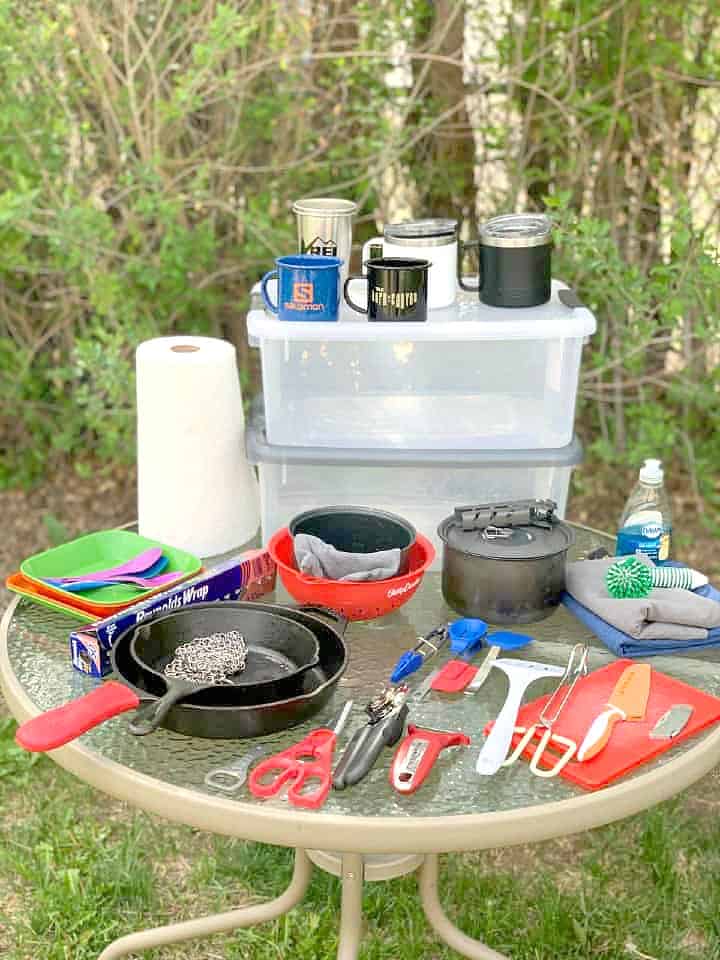 kitchen camping gear spread out on glass top table