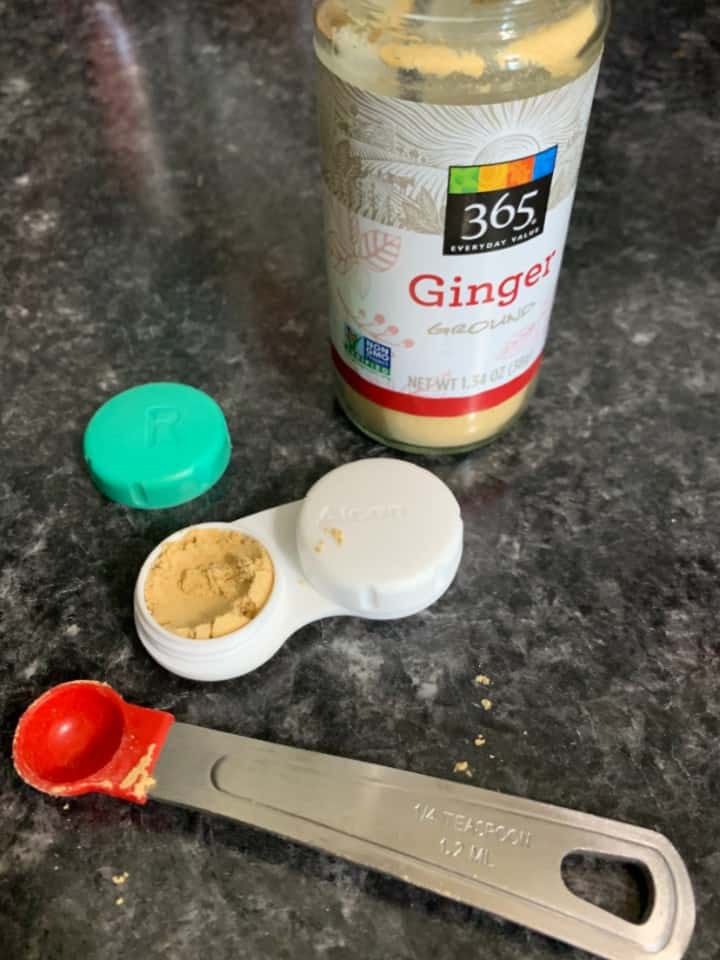 contact case with ginger and measuring spoon